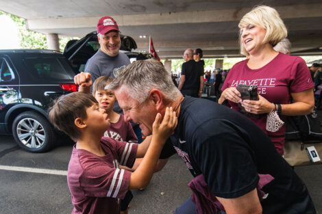 Families mingle on Markle Parking Deck while tailgating.