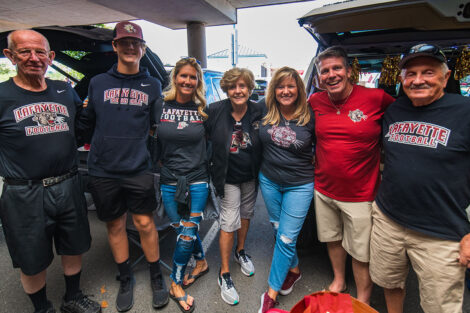 Families smile on Markle Parking Deck while tailgating.