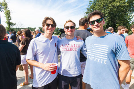 Families smile on Markle Parking Deck while tailgating.