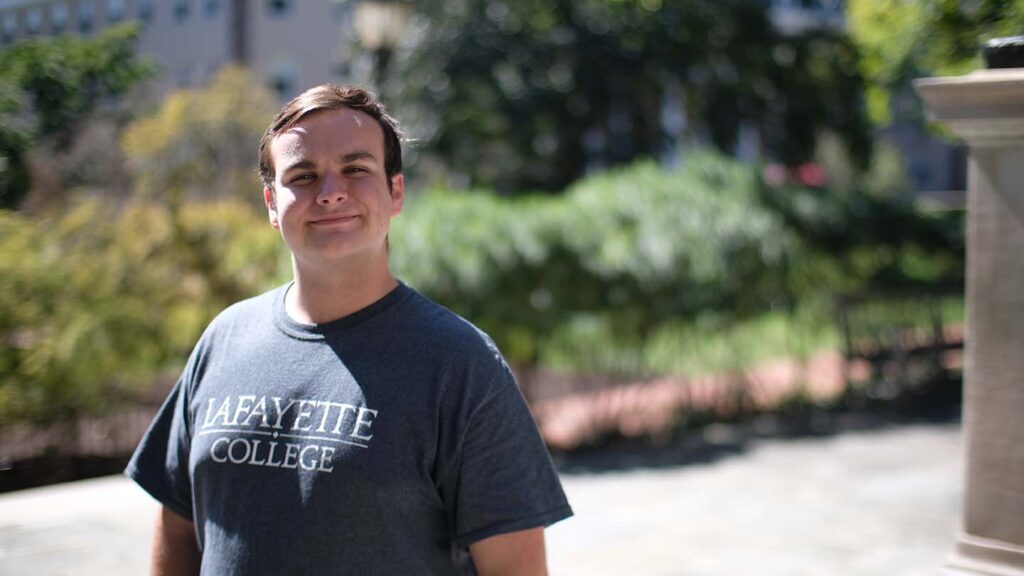 Chris Taverner stands near the Marquis statue behind Colton