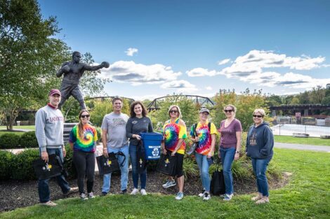 Volunteers, including President Nicole Farmer Hurd, stand at Riverside Park.