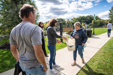 Volunteers, including President Nicole Farmer Hurd and Bill Hurd, prepare to volunteer at Riverside Park.