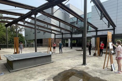 A wide view of the plaza with many students at easels