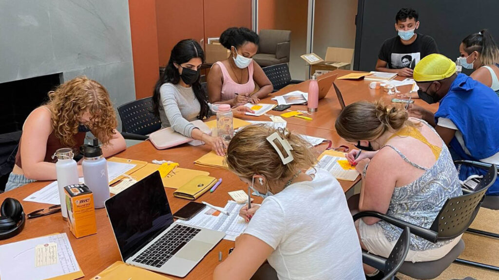 students sit around a table in Skillman library and work