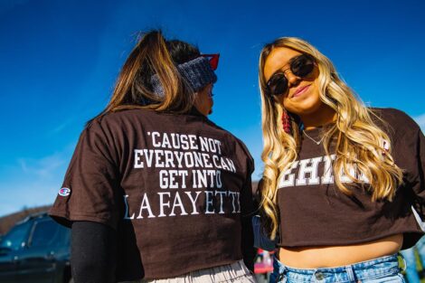 two students show off matching shirts: front says Lehigh; back says 'cause not everyone can get into Lafayette