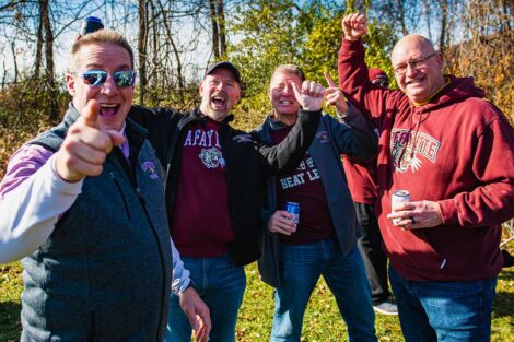 group of alumni in Lafayette gear smile outside