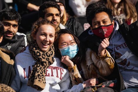 group of students in the stands smile