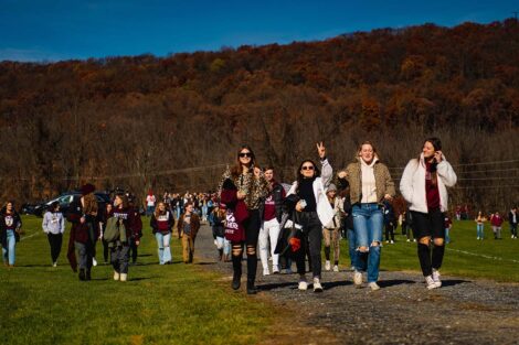 group of students in Lafayette gear smile and walk toward Goodman Stadium