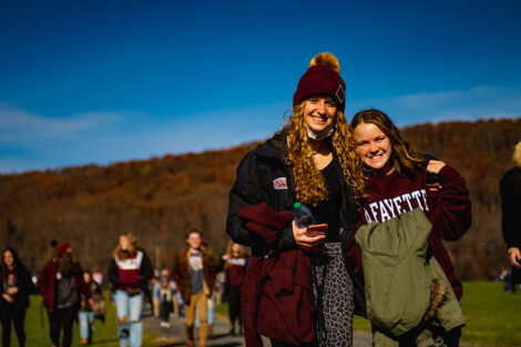 two students smile in Lafayette gear outside Goodman Stadium