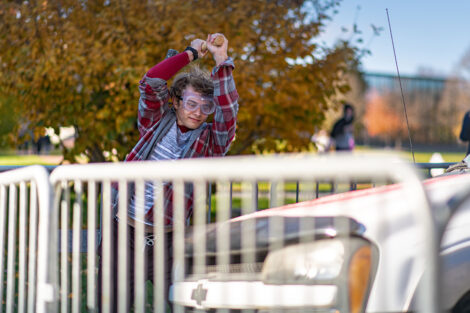 A student swings a sledgehammer.