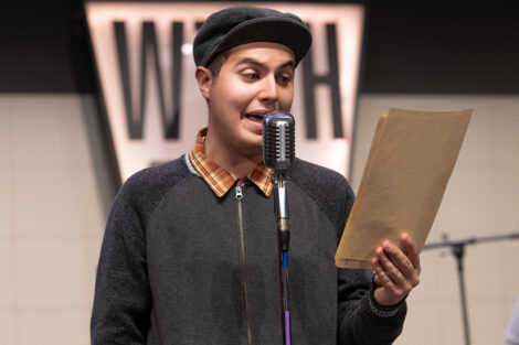 student performers in vintage clothing perform on stage with retro microphones