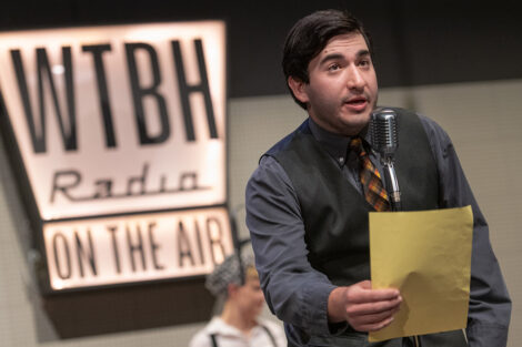 student performers in vintage clothing perform on stage with retro microphones