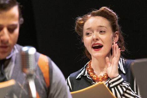 student performer in vintage dress performs on stage