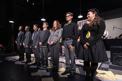 student performers gather on stage for final ovation