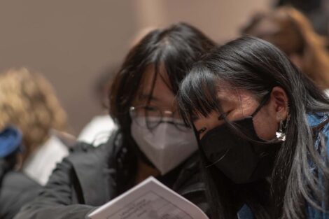 audience members review the program
