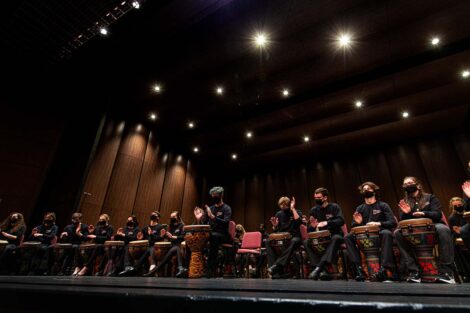 the stage is full of drummers at seats