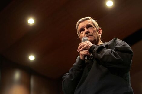 Prof. Stockton holds a mic in his hand