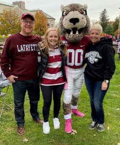 Bryn Cranswick ’23 and her parents, Russ Cranswick P’23 and Sheila Black P’23 pose with the Lafayette leopard on campus