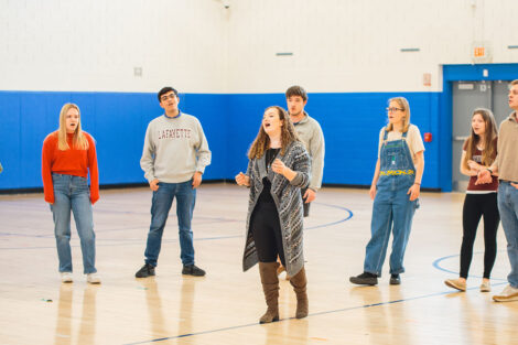 Lafayette students sing in an elementary school gymnasium