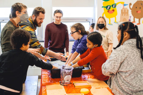 Lafayette student guides young elementary students through a paper making activity