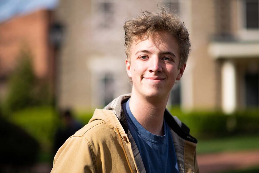 Corey Beck smiles on campus