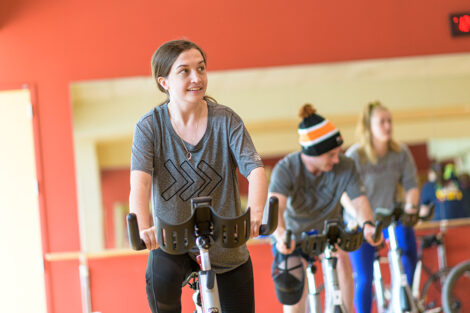 student rides a spin bike