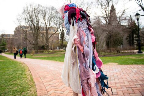 Student is draped in bras