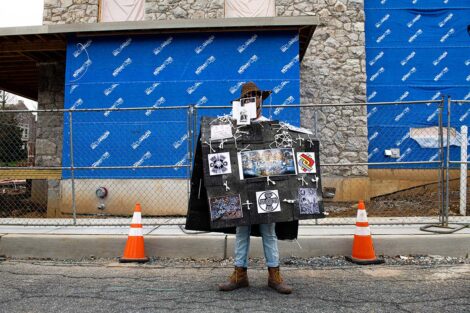 Student in sarape that is covered with photos