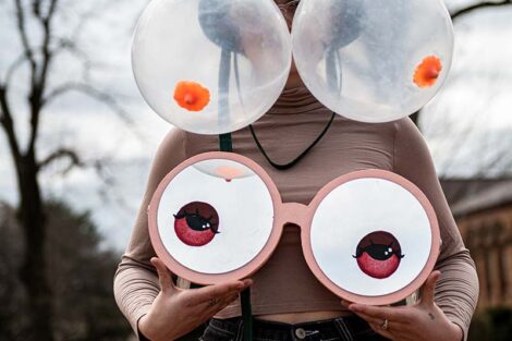 Balloon breasts appear where the eyes should be and eyes where the breasts should be
