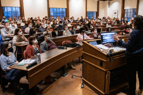 a room in Kirby Hall of Civil rights is filled with faculty and students sitting and listening to a lecturer