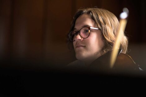 Beth Ann peers over a music stand