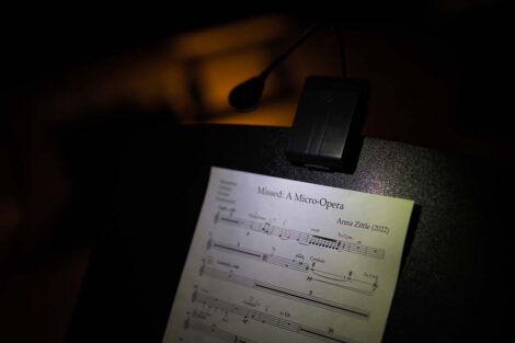 Sheet music sits on a stand