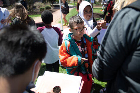 young children gather on the Quad