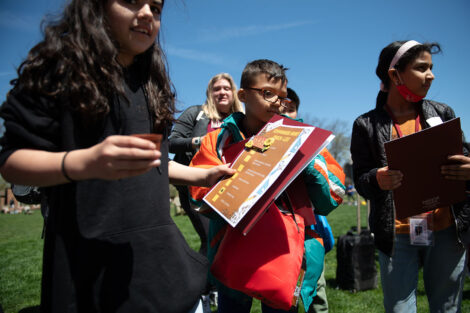 young children gather on the Quad