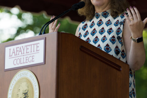 President Hurd stands at podium and talks