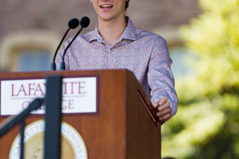 student talks at podium