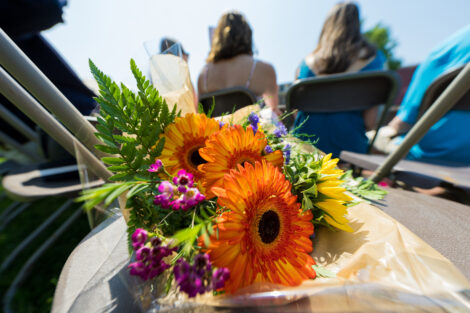 colorful bouquet of flowers sit on a chair