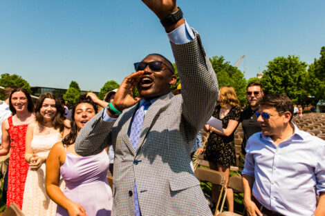 student raises arm and cheers