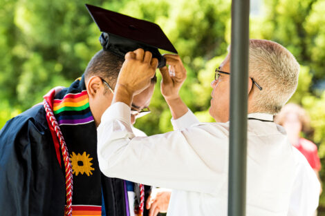 parent adjusts student's cap
