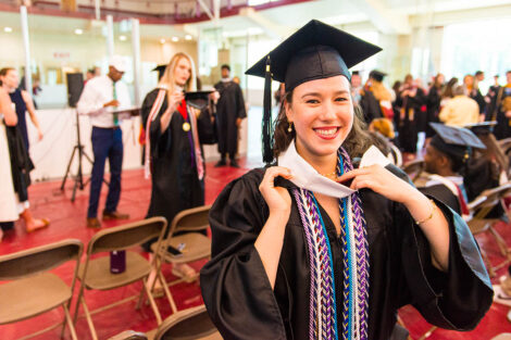 student in graduation cap smiles