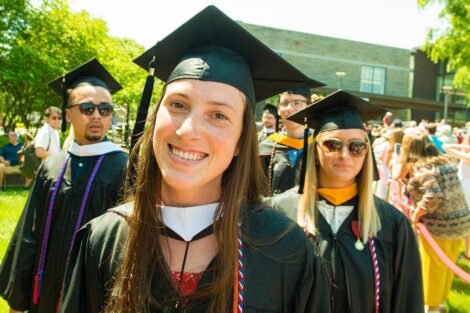 student in graduation cap smiles