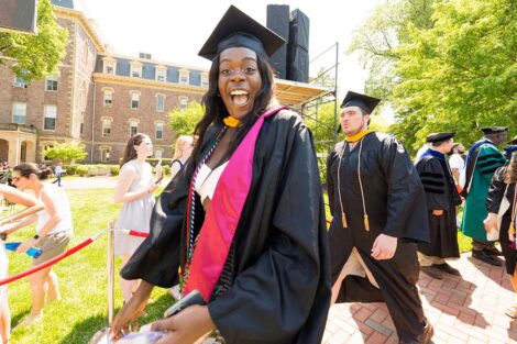 student in graduation cap smiles