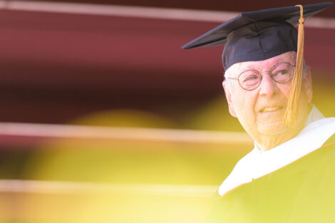 Walter Scott in cap and gown on stage