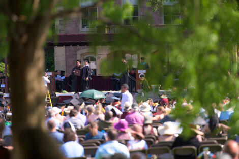 Nicole Hurd presents diploma to student on stage