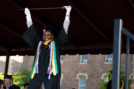 Alex Ashley raises sword and smiles