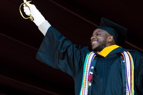 Alex Ashley raises sword and smiles