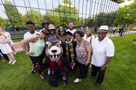 family members smile and take photos of graduates