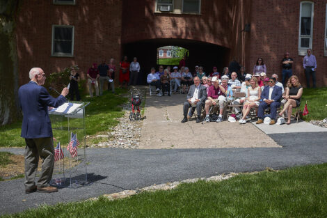 A crowd of Lafayette community members sit, listening to a speaker.