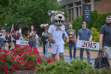 The Leopard walks with alumni during a parade.