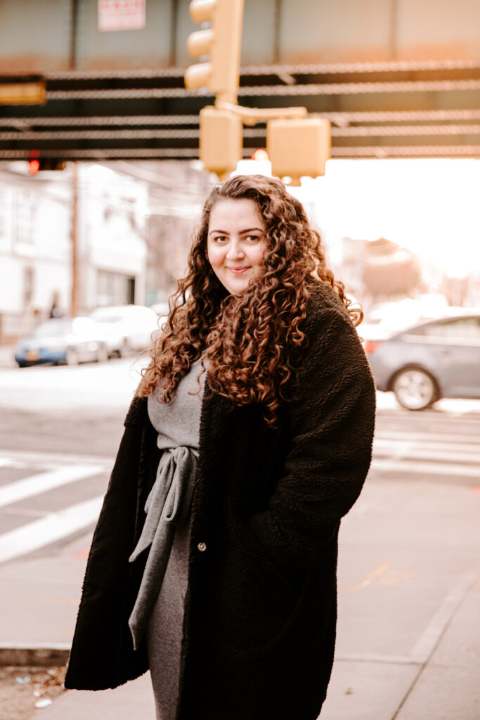 Ayat Husseini '20 poses on a city street